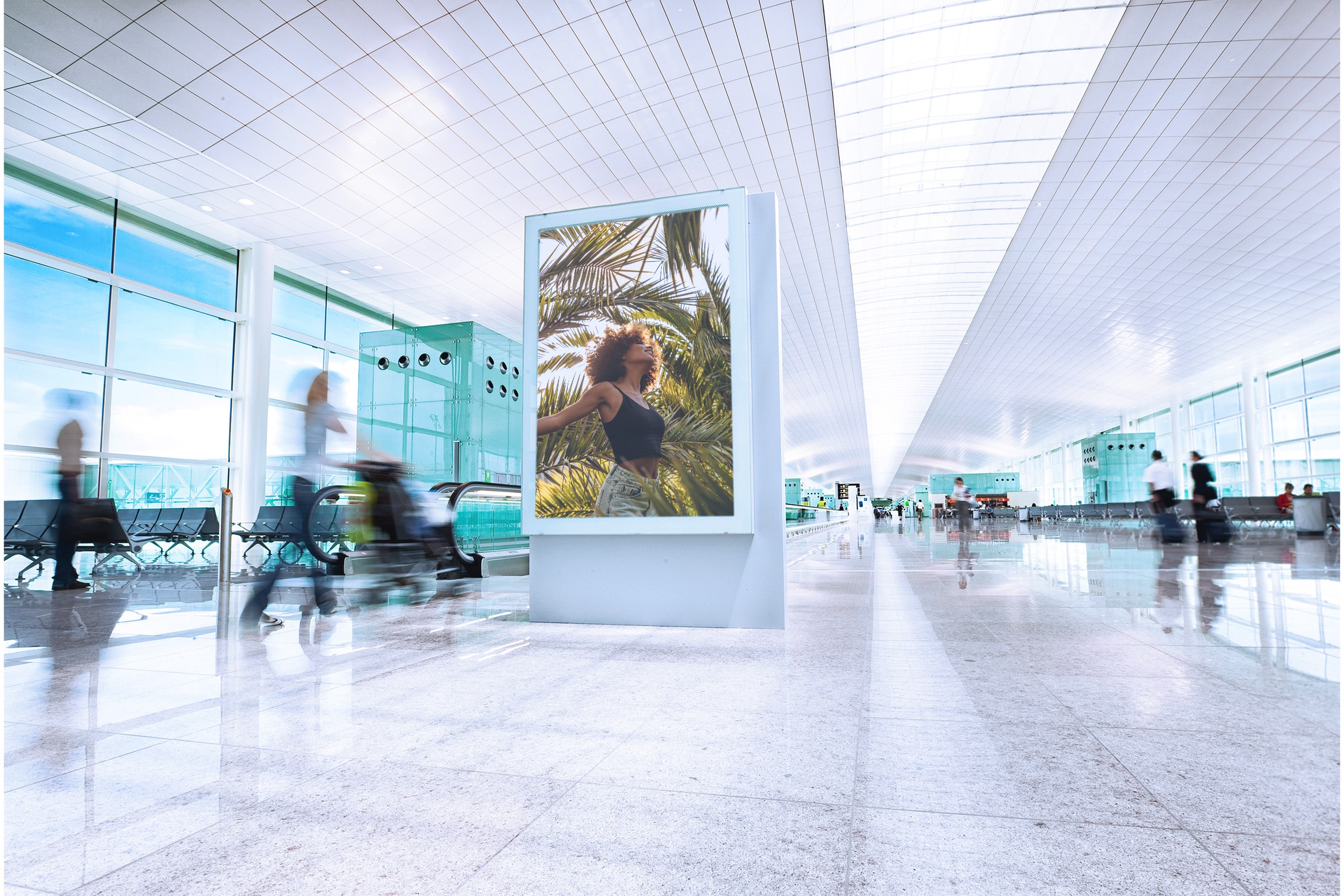 Digital out of home advertising screen placed inside a modern airport terminal with travelers moving through the space.