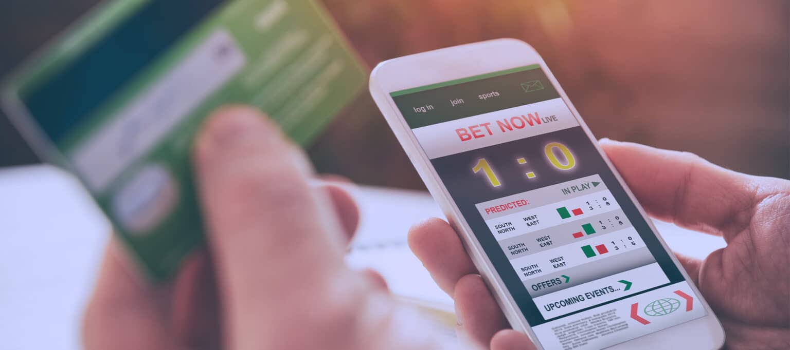 Smartphone displaying a live sports betting interface with match score and betting options.
