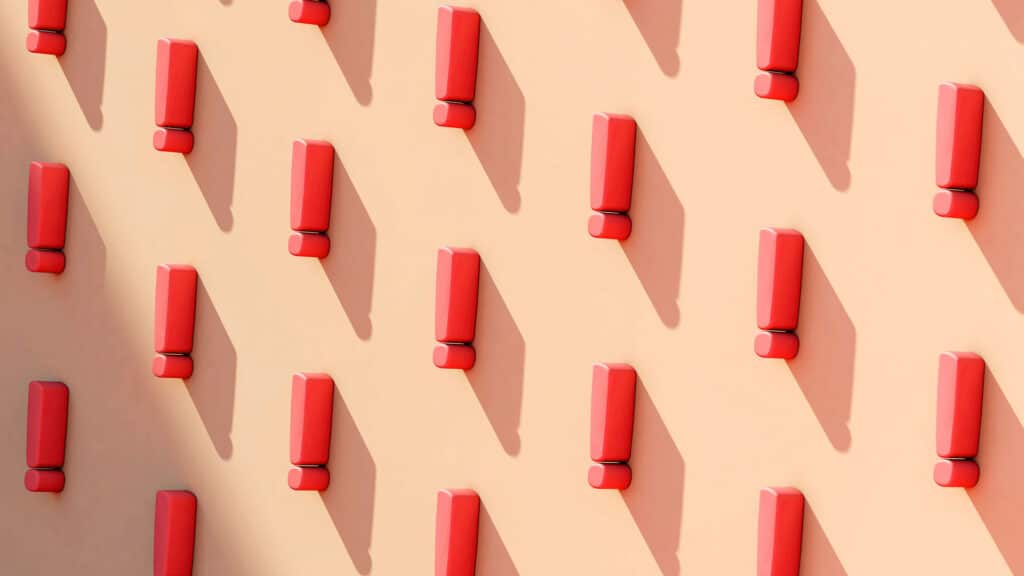 Repeating pattern of red exclamation points casting shadows on a peach background.