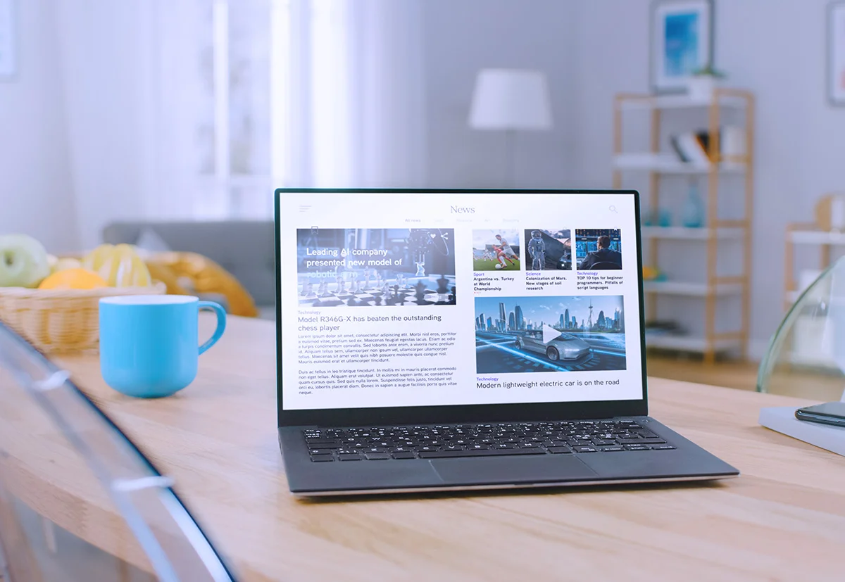 laptop on desk with cup
