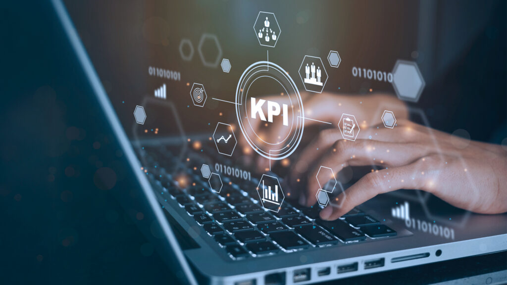 Person typing on laptop with KPI dashboard overlay representing CTV measurement metrics and campaign performance tracking.